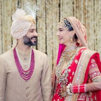 Actress Sonam Kapoor, who has earned the 'fashionista' tag in Bollywood with her experimental taste, chose a traditional bright red lehenga with heavy jewellery for her wedding day as she tied the knot with long-time beau Anand Ahuja at a ceremony here on Tuesday morning. Sonam wore a lotus-motif ensemble by designer Anuradha Vakil and looked every bit the Punjabi bride with her hands adorned by a deep maroon colour of henna, both wrists full of the 'chooda' and 'kaleere'. She wore a statement maatha-patti. The groom, a Delhi-based businessman, too looked dapper in a Raghavendra Rathore creation, a beige sherwani. He paired his sherwani with a beige and cream 'saafa' along with pearl and ruby strings.