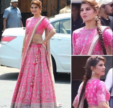 Jacqueline Fernandez has been omnipresent the last week, courtesy Race 3 and her best friend Sonam Kapoor's wedding. Like any girl pal, Jacqueline wrapped her work commitments with co-star Salman Khan and made it in time for pre nuptials and wedding ceremonies of Sonam Kapoor. After touching down to Mumbai after a snow clad schedule of Race 3 in Sonamarg, Jacqueline was out and about the city in a orcher yellow separates and mint blue shrug as she wrapped her dubbing for Race 3 and dashed into the Kapoor residence for dance practices. Starting from her Mehendi ceremony outfit till the reception the actress made heads turns with whatever she wore. 1) She stunned everyone yet again wearing a pink color lehenga at her Best friend Sonam Kapoor's wedding. Jacqueline Fernandez looked like a princess as she adorned hot pink lehenga set. The pink Anita Dongre lehenga had elaborate motifs on it and paired it with a complimenting dupatta. The actress accessorized her look with a pair of gold and pearl chandbali-inspired earrings and a Kundan handcuff.