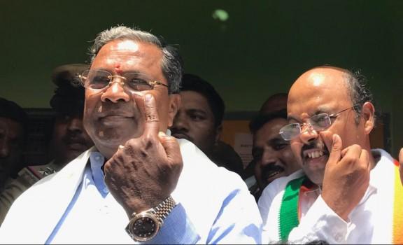 Voting began on Saturday on a brisk note across Karnataka to elect its 15th Legislative Assembly for a five-year term. Denizens of Bengaluru were seen lined up outside polling booths from 6.30 a.m. to beat the rush in casting their ballots as voting began at 7 a.m. Siddaramaiah and his son Yatindra vote in Varuna.