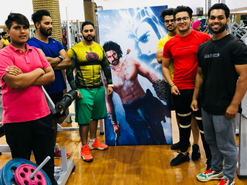 Even after a year since its release Baahubali stays to be the highest grosser in Punjab, box office is a testimony of Prabhas' stardom in Punjab. Owing to his fanbase in Punjab, the gym has installed his life-size poster in their premises. With the release of Baahubali, an unprecedented feat was witnessed when a Southern Superstar stirred a rage in the north. Prabhas' fandom in Punjab isn't a hidden fact, here is the latest testimony of the admiration his fans in Punjab have for him. Baahubali superstar,Baahubali actor,Prabhas,actor Prabhas,Prabhas turns Poster boy,Baahubali gym,Prabhas stardom