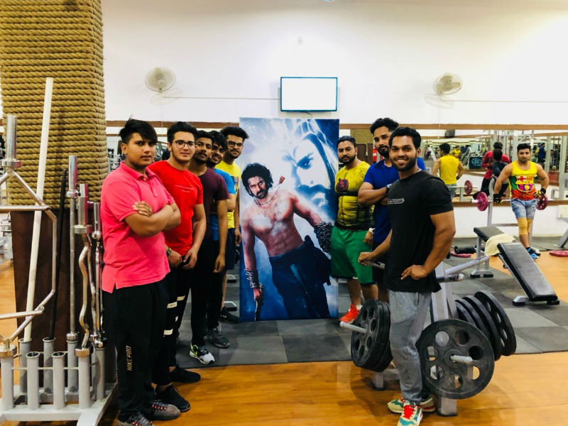 His dedication for Baahubali franchise had him relentlessly working out to achieve a muscular physique. Many fitness enthusiasts look up to his stature, so much so that a gym in Barnala, Punjab has installed a life-size poster of Prabhas as motivation to fitness freaks during their workout sessions at the gym. Baahubali superstar,Baahubali actor,Prabhas,actor Prabhas,Prabhas turns Poster boy,Baahubali gym,Prabhas stardom