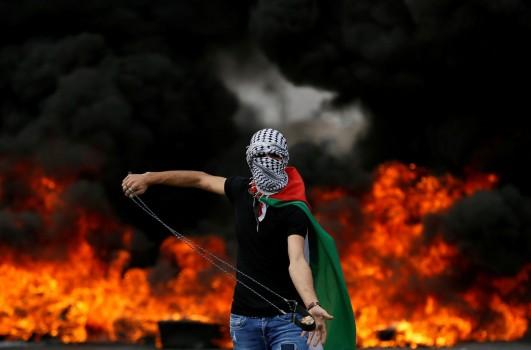 Clashes between Palestinians and Israeli forces break out during the 70th anniversary of Nakba, when hundreds of thousands fled or were driven from their homes in violence culminating in war between the newly created Jewish state and its Arab neighbors in 1948. A Palestinian demonstrator holds a sling during a protest marking the 70th anniversary of Nakba, near the Jewish settlement of Beit El, near Ramallah, in the occupied West Bank May 15, 2018.