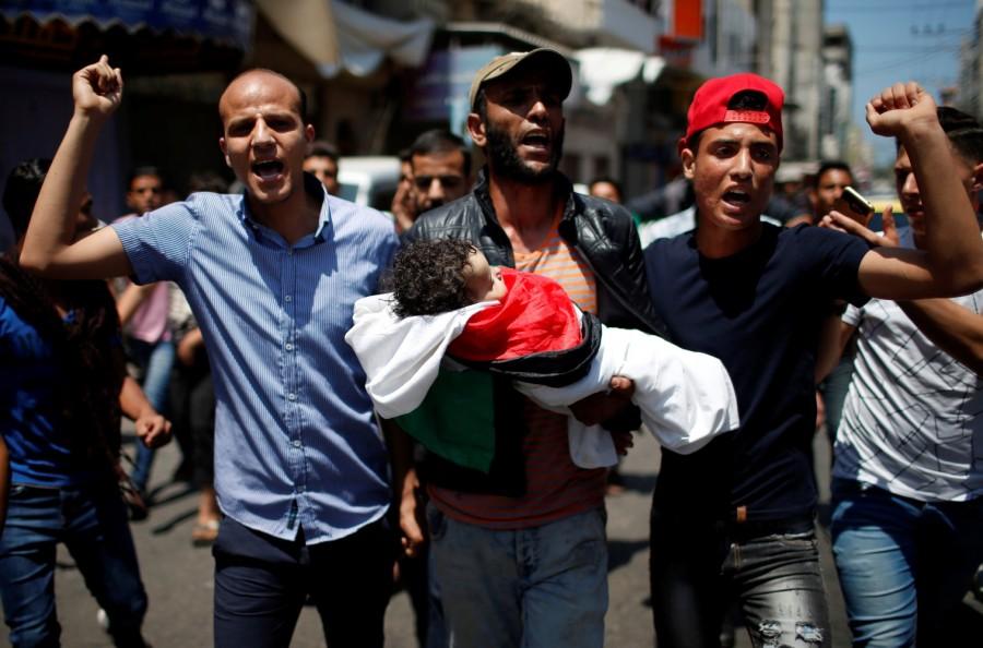 Mourners carry the body of eight-month-old Palestinian infant Laila al-Ghandour, who died after inhaling tear gas during a protest against U.S embassy move to Jerusalem at the Israel-Gaza border, during her funeral in Gaza City May 15, 2018. Palestinian baby,border protest,Palestinian border protest,Israel-Gaza border,Laila al-Ghandour