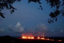 Lava erupts from a fissure on the outskirts of Pahoa during ongoing eruptions of the Kilauea Volcano in Hawaii, U.S., May 14, 2018. Governor David Ige has asked President Donald Trump to issue a disaster declaration for Hawaii as a result of the ongoing earthquakes and volcano eruption, according to a press release. The declaration allows federal funds to begin to flow to state and local efforts in Hawaii. The Kilauea eruption last week created new volcanic vents on the ground miles east of the summit, releasing slow-moving lava and toxic gas into island communities.