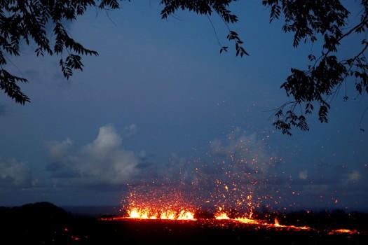 Lava erupts from a fissure on the outskirts of Pahoa during ongoing eruptions of the Kilauea Volcano in Hawaii, U.S., May 14, 2018. Governor David Ige has asked President Donald Trump to issue a disaster declaration for Hawaii as a result of the ongoing earthquakes and volcano eruption, according to a press release. The declaration allows federal funds to begin to flow to state and local efforts in Hawaii. The Kilauea eruption last week created new volcanic vents on the ground miles east of the summit, releasing slow-moving lava and toxic gas into island communities.
