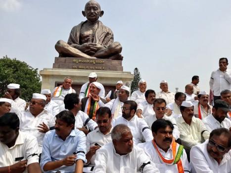 The beleaguered Congress and Janata Dal-Secular (JD-S) leaders on Thursday staged a protest against BJP leader B.S. Yeddyurappa's swearing-in as the Karnataka Chief Minister, terming it unconstitutional. Leaders of the Congress and JD-S, who had hastily stitched a post-poll alliance, staged the protest in front of the state legislature building soon after Yeddyurappa was administered the oath of office by Governor Vajubhai R. Vala at the Raj Bhavan. 