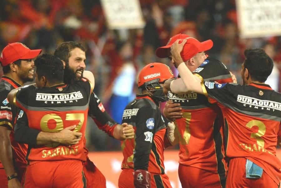 Royal Challengers Bangalore kept their playoff hopes alive as Sunrisers Hyderabad's skipper Kane Williamson (81 off 42) and Manish Pandey's (62 not-out off 38) blistering knock went in vain in a crucial Indian Premier League (IPL) clash at M. Chinnaswamy Stadium here on Thursday. It was once again Williamson, who along with Pandey forged a crucial partnership to take Hyderabad on the verge of another nail-biting win. However, it was the hosts who clinched the issue by 14 runs to keep their playoff dream alive. Chasing the massive 219-run target, Hyderabad openers Shikhar Dhawan (18) and Alex Hales (37) took their side to a quick start, accumulating 47 runs in the first five overs. However, the decent start was short-lived as Yuzvendra Chahal drew the first blood for the hosts in the sixth over when Dhawan came down the track but chipped back to the bowler. With addition of another 17 runs in Hyderabad's scorecard, AB de Villiers took a stunning catch at deep midwicket to pack back Hales off a Moeen Ali delivery. Royal Challengers Bangalore,Sunrisers Hyderabad,RCB beats SRH,Kane Williamson,Manish Pandey,Virat Kohli,Indian Premier League,Indian Premier League 2018,Ipl 2018