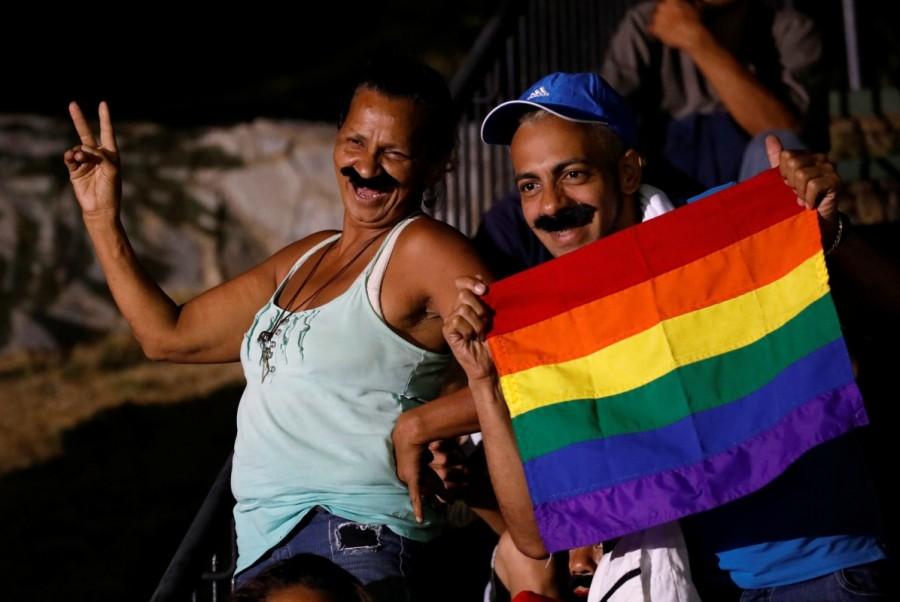Supporters wear mustaches depicting Venezuela's President Nicolas Maduro while he speaks during a gathering after the results of the election were released, outside of the Miraflores Palace in Caracas, Venezuela, May 20, 2018. Nicolas Maduro,President Nicolas Maduro,Nicolas Maduro re-elected