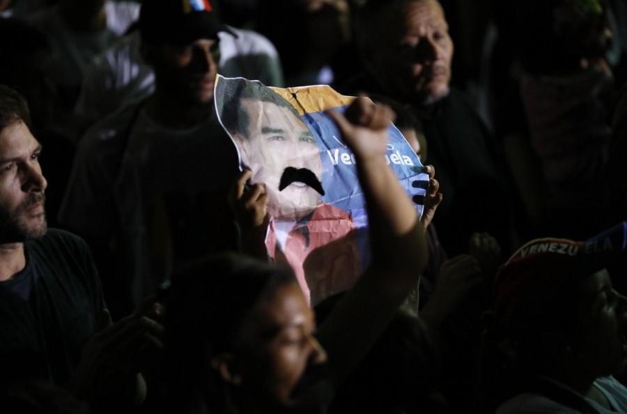 An image depicting Venezuela's President Nicolas Maduro's mustache is held up while he speaks during a gathering after the results of the election were released, outside of the Miraflores Palace in Caracas, Venezuela, May 20, 2018. Nicolas Maduro,President Nicolas Maduro,Nicolas Maduro re-elected