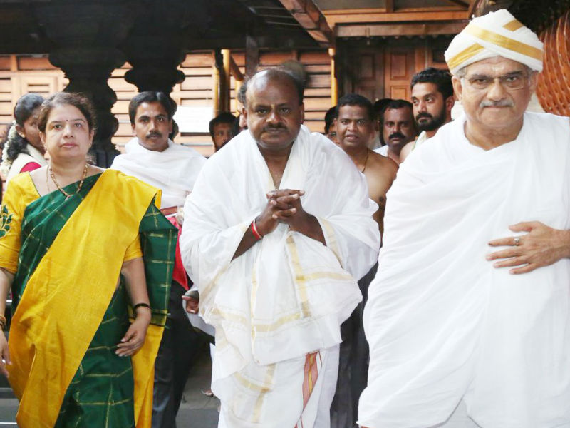 A day ahead of his swearing-in, Karnataka Chief Minister-designate H.D. Kumaraswamy on Tuesday visited the Hindu holy towns of Dharmasthala and Sringeri to pray for the success of the Congress-(JD-S) coalition government. The Janata Dal-Secular (JD-S) leader returned to the southern state after a day-long visit on Monday to Delhi to discuss government formation with Congress leaders Sonia Gandhi and Rahul Gandhi. "Although the people did not bless me and our party with a clear mandate, I have got an opportunity again to serve them by God's grace and my parents' blessings," Kumaraswamy had told reporters on Monday. Kumaraswamy,hd kumaraswamy,Kumaraswamy at Dharmasthala,Kumaraswamy swearing-in,hd kumaraswamy swearing-in ceremony,Kumaraswamy seeks blessings