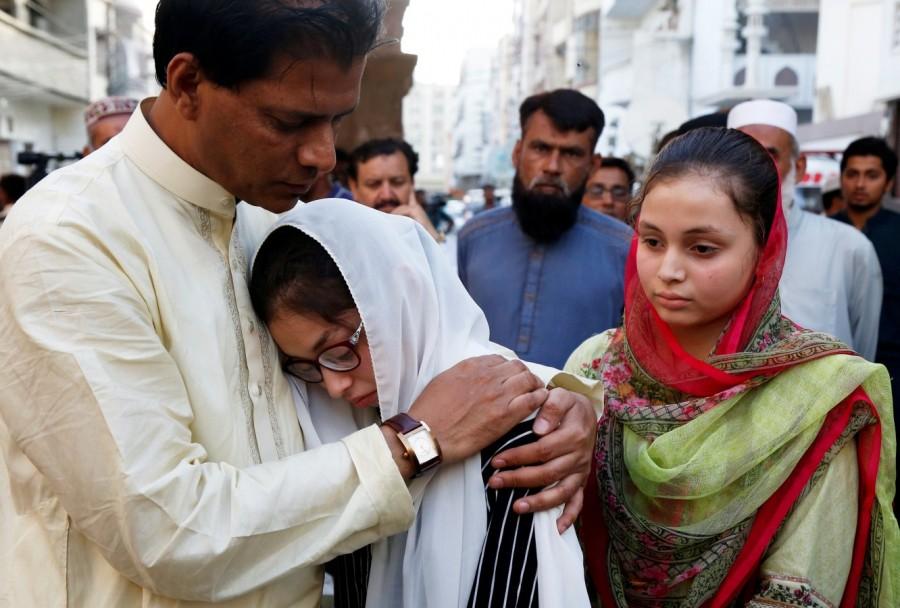 Aziz Sheikh (L) father of Sabika Aziz Sheikh, a Pakistani exchange student, who was killed with others when a gunman attacked Santa Fe High School in Santa Fe, Texas, U.S., comforts her friends, during a funeral in Karachi, Pakistan May 23, 2018. Funeral for Pakistani student,Pakistani student,Texas school shooting,Texas shooting,texas shooting incident,Texas shooting 26 killed,South Texas shooting