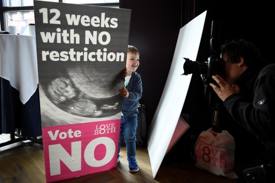 Rossi Maloney aged 2 who featured as a 'No' campaign poster child after his mother Emma Maloney credits the 8th Amendment for saving his life after an unplanned pregnancy, holds a Pro-Life poster ahead of a 25th May referendum on abortion law, in Dublin, Ireland, May 23, 2018. Abortion referendum,Pro-Choice mural,abortion law,Ireland