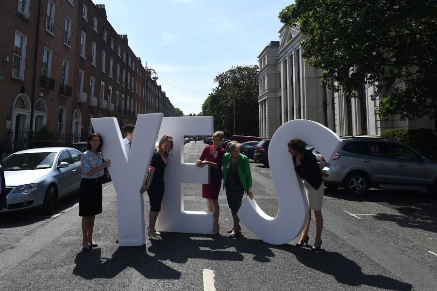 Politicians struggle with a 'Yes' sign in front of St. Stephen's church on a street ahead of a 25th May referendum on abortion law, in Dublin, Ireland, May 23, 2018. Abortion referendum,Pro-Choice mural,abortion law,Ireland