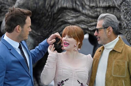 Cast members (L to R) Chris Pratt, Bryce Dallas Howard, and Jeff Goldblum pose in front of a model dinosaur during a photocall to promote the forthcoming film 'Jurassic World: Fallen Kingdom' in London, Britain, May 24, 2018. Universal Pictures India's 