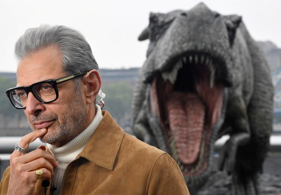 Cast member Jeff Goldblum conducts an interview near a model dinosaur during a photocall to promote the forthcoming film 'Jurassic World: Fallen Kingdom' in London, Britain, May 24, 2018. Chris Pratt,Bryce Dallas Howard,Jeff Goldblum,Jurassic World: Fallen Kingdom Photocall,Jurassic World,Fallen Kingdom Photocall