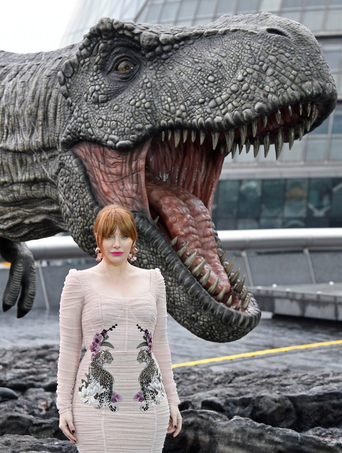 Cast member Bryce Dallas Howard poses in front of a model dinosaur during a photocall to promote the forthcoming film 'Jurassic World: Fallen Kingdom' in London, Britain, May 24, 2018. Chris Pratt,Bryce Dallas Howard,Jeff Goldblum,Jurassic World: Fallen Kingdom Photocall,Jurassic World,Fallen Kingdom Photocall