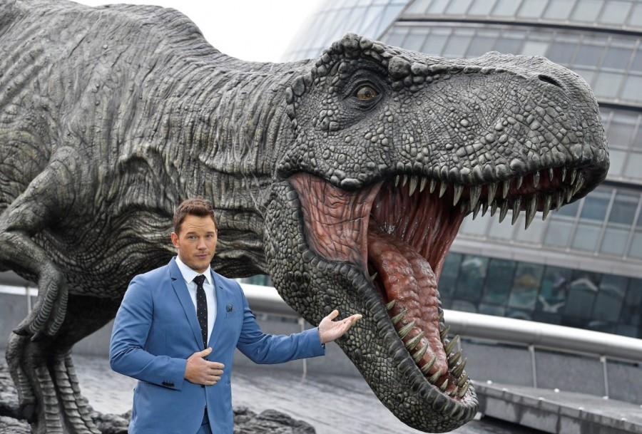 Cast member Chris Pratt poses in front of a model dinosaur during a photocall to promote the forthcoming film 'Jurassic World: Fallen Kingdom' in London, Britain, May 24, 2018. Chris Pratt,Bryce Dallas Howard,Jeff Goldblum,Jurassic World: Fallen Kingdom Photocall,Jurassic World,Fallen Kingdom Photocall
