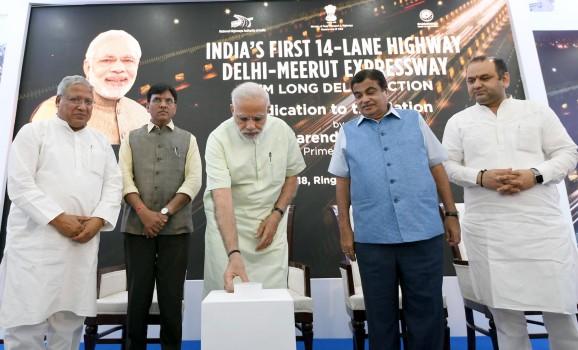 Prime Minister Narendra Modi travelled in an open jeep on the Delhi-Meerut Expressway after inaugurating its first phase here on Sunday. The first phase of the Delhi-Meerut Expressway cost Rs 842 crore on building the 9-km stretch of the 14-lane highway. The total cost of the project on completion would be Rs 7,500 crore. Once the entire project is complete, it will take 60 minutes to travel from Delhi to Meerut. The Prime Minister's road show commenced from the Nizamuddin Bridge, the start of the about 9 km first leg of the expressway. The total length of the project is 82 km, of which the first 27.74 kms will have 14 lanes, while the rest will be a six-lane expressway. After a 6-km travel on the stretch, Modi flew to Baghpat to inaugurate the 135-km Kundli-Ghaziabad-Palwal (KGP) Expressway (Eastern Peripheral Expressway), built at a cost of Rs 11,000 crore.