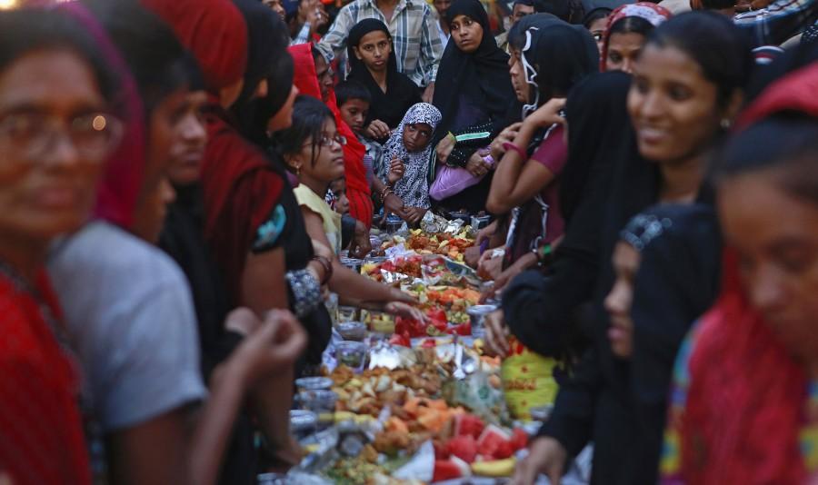 Women wait to have their iftar (breaking fast) meal at a street during the holy month of Ramadan in Mumbai. Ramadan 2018,Ramadan,happy Ramadan,Ramadan fasting,breaking their fast,people breaking their fast,Ramadan 2018 pics,Ramadan 2018 images,Ramadan 2018 stills,Ramadan 2018 pictures,iftar,ramadan iftar