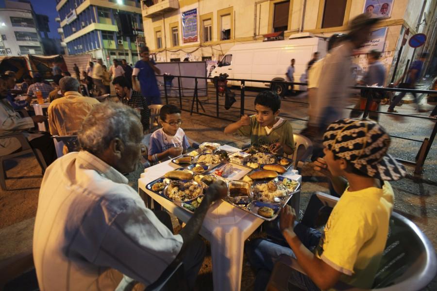 Muslims break fast at the end of the day of Ramadan near the court house in Benghazi. Muslims around the world abstain from eating, drinking and conducting sexual relations from sunrise to sunset during Ramadan, the holiest month in the Islamic calendar. Ramadan 2018,Ramadan,happy Ramadan,Ramadan fasting,breaking their fast,people breaking their fast,Ramadan 2018 pics,Ramadan 2018 images,Ramadan 2018 stills,Ramadan 2018 pictures,iftar,ramadan iftar