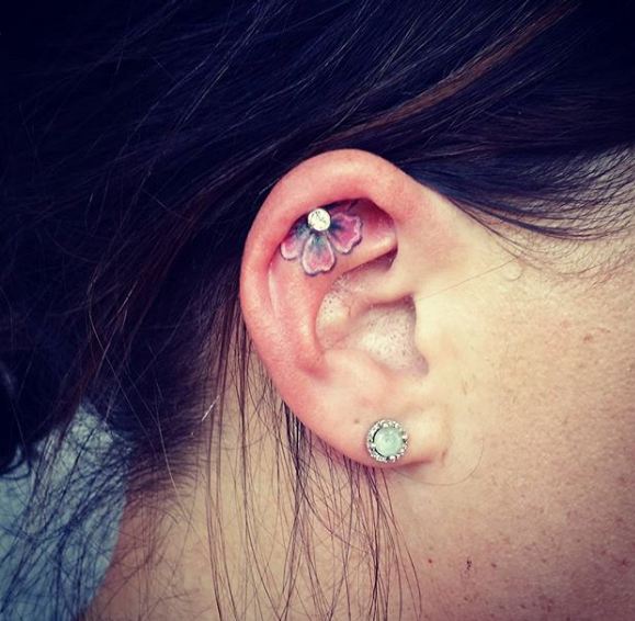 Tiny ear flower tattoo
