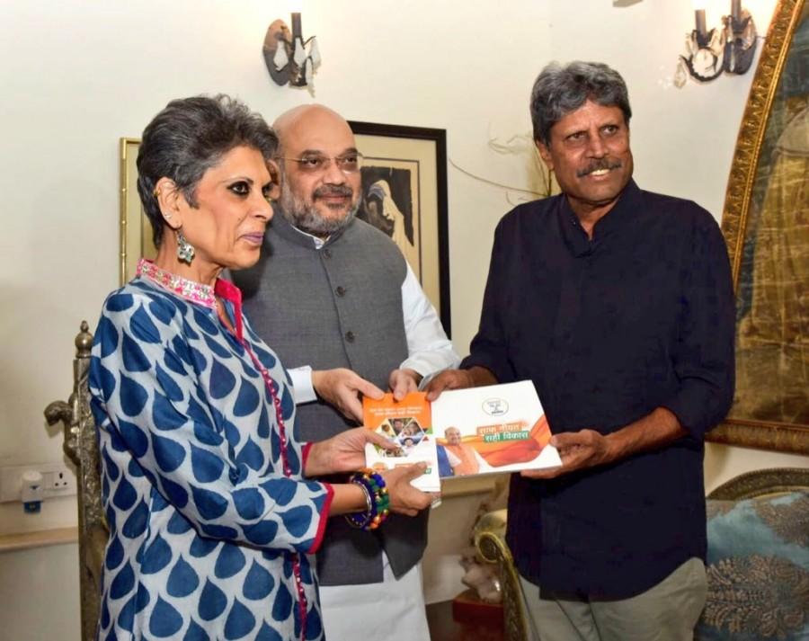 BJP President Amit Shah on Friday met former Indian cricket team captain Kapil Dev as part of his party's nationwide "Sampark Se Samarthan" (contact for support) personal outreach programme to highlight the achievements of the Narendra Modi-led government in the last four years. Shah arrived at the residence of India's first World Cup winning skipper in south Delhi's Sundar Nagar and handed him some booklets depicting the achievements of the Modi government. The Bharatiya Janata Party (BJP) leader kicked off the massive outreach programme on Tuesday by calling on former Army chief General Dalbir Singh Suhag at his Delhi residence. Shah also met former Secretary General of the Lok Sabha and constitutional expert Subhash Kashyap. Shah is scheduled to personally meet at least 50 eminent personalities to apprise them of the BJP-led National Democratic Alliance (NDA) government's achievements. BJP President Amit Shah,Amit Shah,Amit Shah meets Kapil Dev,Kapil Dev,former Indian cricket team captain Kapil Dev,Sampark Se Samarthan,BJP
