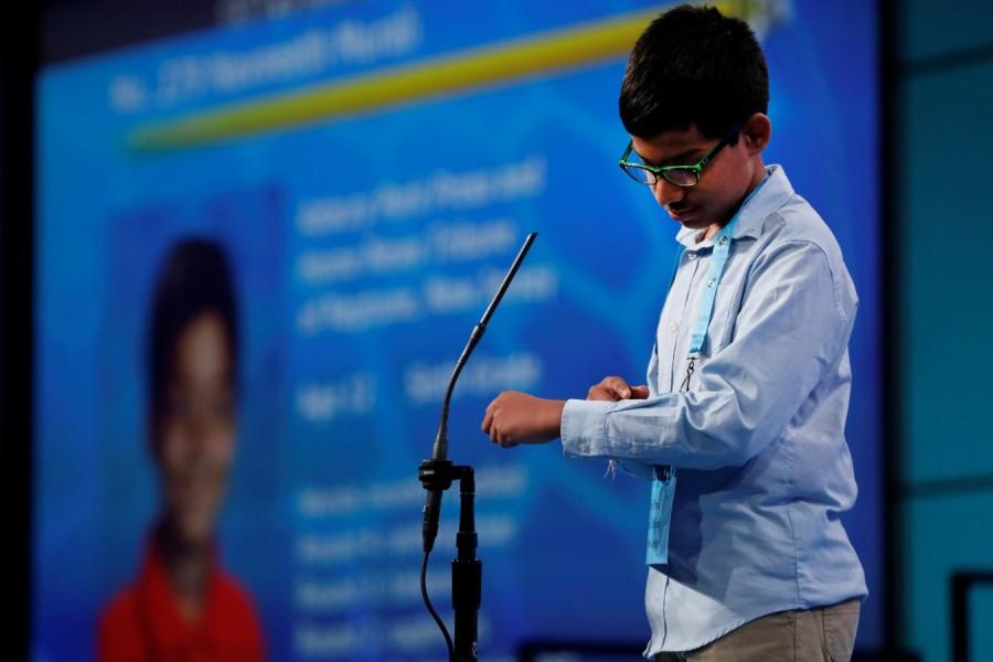 Naveenth Murali spells a word on his forearm during the Scripps National Spelling Bee at National Harbor in Oxon Hill, Maryland, U.S., May 31, 2018. Karthik Nemmani,Karthik Nemmani wins National Spelling Bee,National Spelling Bee,Indian-American,National Spelling Bee winner,Scripps national spelling bee,Koinonia