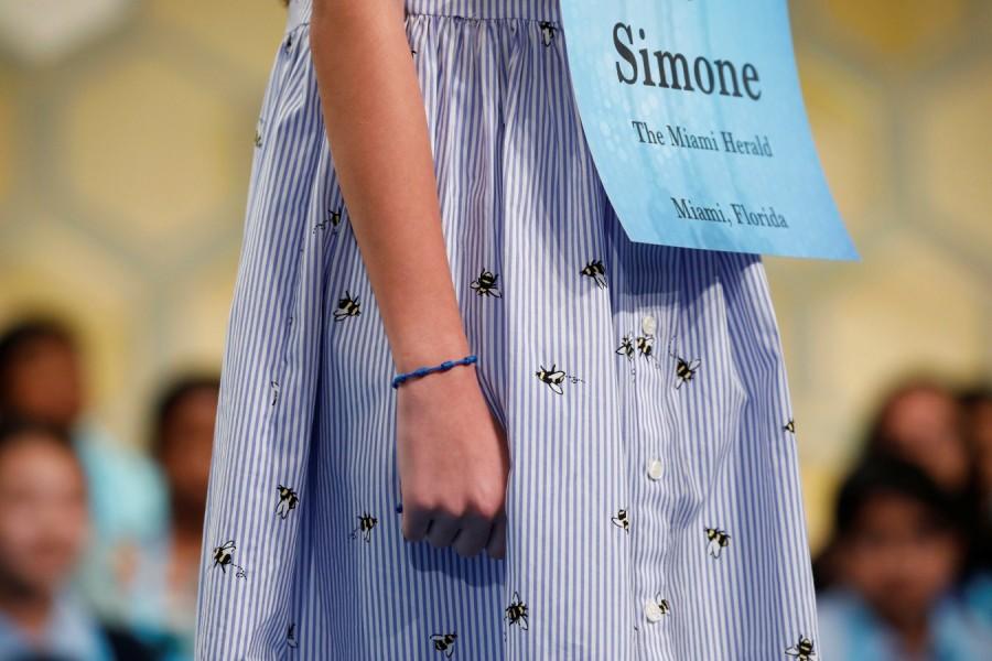 Simone Kaplan wears a dress featuring bees as she participates in the Scripps National Spelling Bee at National Harbor in Oxon Hill, Maryland, U.S., May 31, 2018. Karthik Nemmani,Karthik Nemmani wins National Spelling Bee,National Spelling Bee,Indian-American,National Spelling Bee winner,Scripps national spelling bee,Koinonia