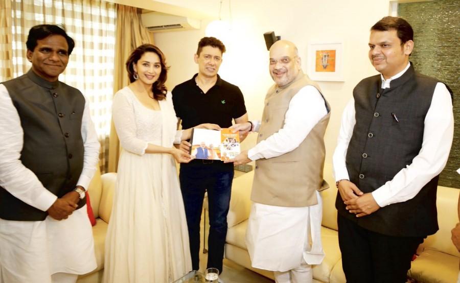 Bhartiya Janata Party president Amit Shah takes Sampark for Samarthan to Bollywood, meets Bollywood actress Madhuri Dixit. The pics were shared by Amit Shah on Twitter with the caption: It was pleasant meeting the noted bollywood actress @MadhuriDixit and Dr. Shriram Nene as a part of "Sampark For Samarthan" initiative at their home in Mumbai, Maharashtra. Have discussed the achievements and path breaking initiatives of PM @narendramodi govt in last 4 years. Amit Shah,BJP President Amit Shah,Amit shah bjp,president Amit Shah,Amit Shah meets Madhuri Dixit,Madhuri Dixit,Sampark for Samarthan