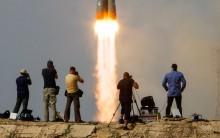 Photographers take pictures as the Soyuz MS-09 spacecraft carrying a crew formed of astronauts Serena Aunon-Chancellor of the U.S and Alexander Gerst of Germany and cosmonaut Sergey Prokopyev of Russia blasts off to the International Space Station (ISS) from the launchpad at the Baikonur Cosmodrome, Kazakhstan June 6, 2018.