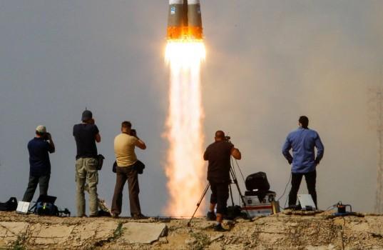 Photographers take pictures as the Soyuz MS-09 spacecraft carrying a crew formed of astronauts Serena Aunon-Chancellor of the U.S and Alexander Gerst of Germany and cosmonaut Sergey Prokopyev of Russia blasts off to the International Space Station (ISS) from the launchpad at the Baikonur Cosmodrome, Kazakhstan June 6, 2018.
