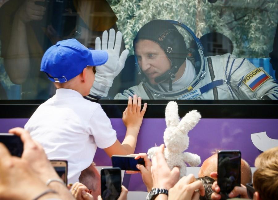 International Space Station (ISS) crew member Sergey Prokopyev of Russia waves to his family from a bus shortly before leaving to board the spacecraft at the Baikonur Cosmodrome, Kazakhstan June 6, 2018. Russian Soyuz capsule,Russian Soyuz rocket,Soyuz rocket,Soyuz MS-09,MS-09 spacecraft,Alexander Gerst,Soyuz blasts off
