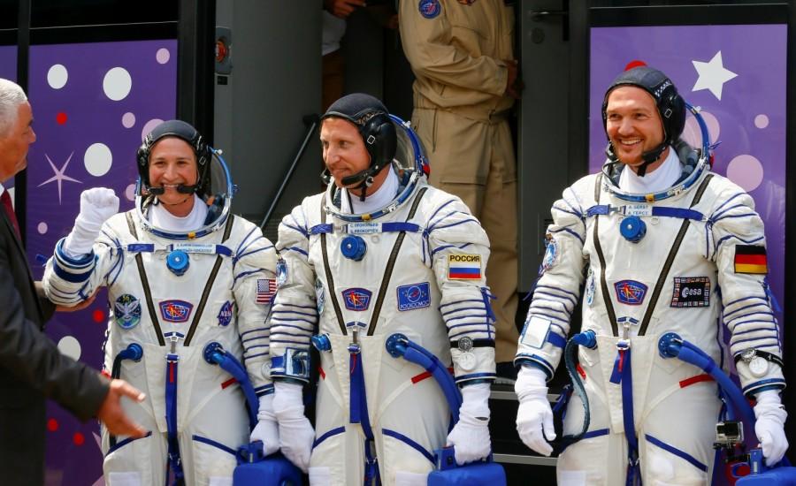 International Space Station (ISS) crew members Serena Aunon-Chancellor of the U.S, Alexander Gerst of Germany and Sergey Prokopyev of Russia walk after donning space suits shortly before their launch at the Baikonur Cosmodrome, Kazakhstan June 6, 2018. Russian Soyuz capsule,Russian Soyuz rocket,Soyuz rocket,Soyuz MS-09,MS-09 spacecraft,Alexander Gerst,Soyuz blasts off