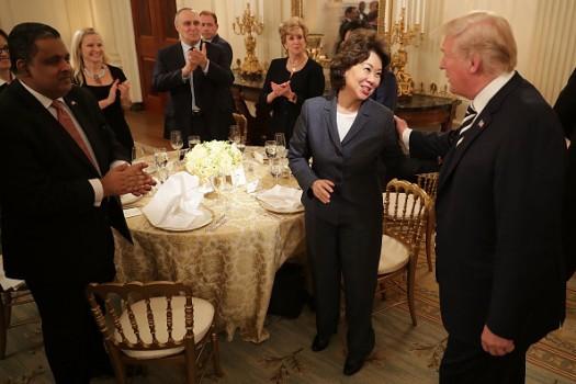 U.S. President Donald Trump (R) greets Secretary of Transportation Elaine Chao and other guests while hosting an Iftar dinner in the State Dining Room at the White House June 6, 2018 in Washington, DC. The Iftar is the dinner that ends the daily fast during the Muslim holy month of Ramadan.