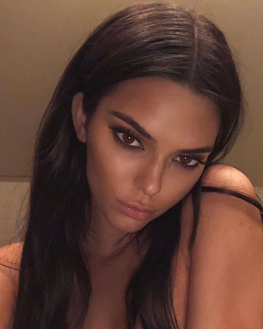 Reality TV star Kendall Jenner took to Instagram to share a topless photograph of herself with her fans and followers. She posted the photograph on Thursday night as she took part in a photo shoot. In the image, shot on her phone into a mirror, Kendall wears a low-cut black one piece --so low-cut that it covers nothing of her breasts. The only thing preserving the star's modesty is two tiny ice-cream emojis. While her head has been cropped out, fans could tell it was her by her sticker covered cellphone. The shoot appeared to be the brainchild of photographer Cass Bird. Kendall Jenner,Kendall Jenner naked,Kendall Jenner topless,Kendall Jenner topless pics,Kendall Jenner topless photo,kendall jenner instagram,Kendall Jenner facebook,Kendall Jenner topless images,Kendall Jenner topless stills