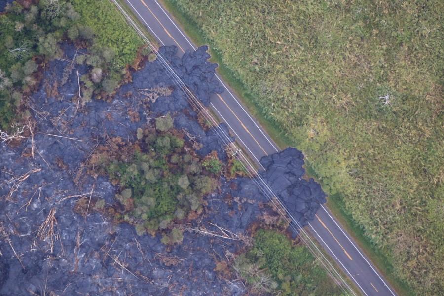 Lava flows across a highway on the outskirts of Pahoa during ongoing eruptions of the Kilauea Volcano in Hawaii, U.S. Kilauea Volcano,Kilauea volcano eruption,Kilauea volcano lava,Kilauea volcano lava flow,Hawaii's Kilauea volcano