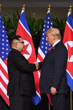 US President Donald Trump shook hands with North Korean leader Kim Jong-un on Tuesday and welcomed the beginning of a 