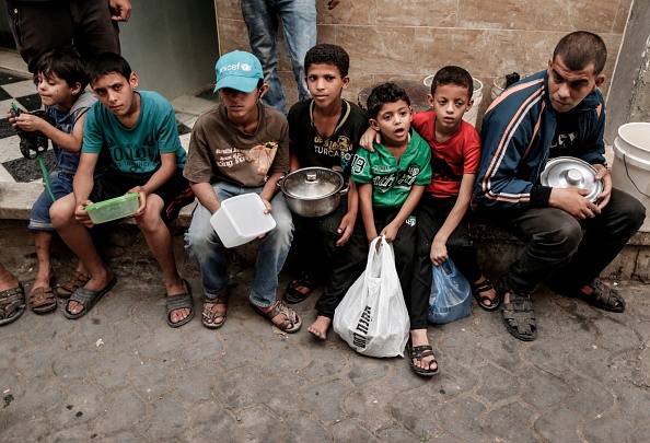 Palestinian children wait to receive free soup during the holy month of Ramadan, in Gaza City on May 27, 2018. Ramadan 2018,Ramadan,Iftar meals,Ramzan Id,Eid-ul-Fitar,Eid-ul-Fitar 2018,Ramadan meals