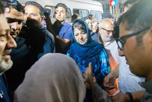 Mehbooba Mufti Chief Minister of Jammu and Kashmir consoles the mother of Syed Shujaat Bukhari, the editor of Rising Kashmir daily newspaper, killed by unidentified gunmen outside his office on June 14, 2018 in Srinagar, the summer capital of Indian administered Kashmir, India. Shujaat Bukhari editor of Rising Kashmir a leading newspaper, journalist has been shot dead along with his two security guards, by unidentified gunmen in Srinagar. Bukhari, was attacked in his car near the office of the Rising Kashmir newspaper. No group has claimed the killings but Indian police say militants are suspected to have carried out the attack. He was in his early 50s and is survived by his wife, son, daughter and parents. Kashmiri journalists have been the targets of both Militants and Indian government forces, and at least dozen have been killed and many wounded since the revolt against Indian rule in 1989.