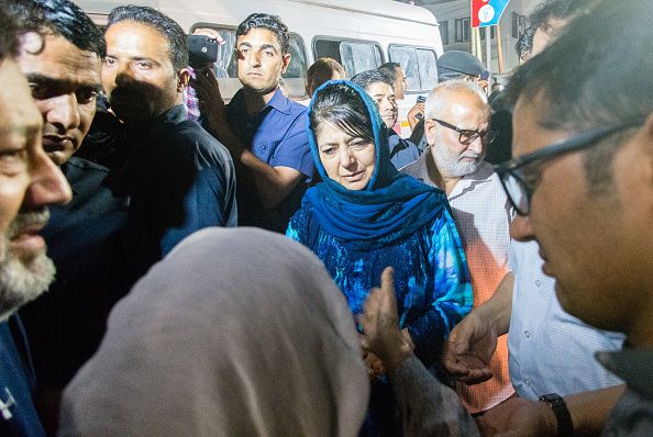 Mehbooba Mufti Chief Minister of Jammu and Kashmir consoles the mother of Syed Shujaat Bukhari, the editor of Rising Kashmir daily newspaper, killed by unidentified gunmen outside his office on June 14, 2018 in Srinagar, the summer capital of Indian administered Kashmir, India. Shujaat Bukhari editor of Rising Kashmir a leading newspaper, journalist has been shot dead along with his two security guards, by unidentified gunmen in Srinagar. Bukhari, was attacked in his car near the office of the Rising Kashmir newspaper. No group has claimed the killings but Indian police say militants are suspected to have carried out the attack. He was in his early 50s and is survived by his wife, son, daughter and parents. Kashmiri journalists have been the targets of both Militants and Indian government forces, and at least dozen have been killed and many wounded since the revolt against Indian rule in 1989. Rising Kashmir,rising kashmir shujat bhukari,Rising Kashmir editor killed,Shujaat Bhukhari,Shujaat Bhukhari funeral,Shujaat Bhukhari funeral pics,Shujaat Bhukhari funeral images,Shujaat Bhukhari dead,Shujaat Bhukhari killed