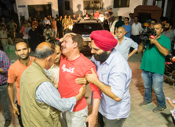 People console a relative of Syed Shujaat Bukhari, the editor of Rising Kashmir daily newspaper, killed by unidentified gunmen outside his office on June 14, 2018 in Srinagar, the summer capital of Indian administered Kashmir, India. Shujaat Bukhari editor of Rising Kashmir a leading newspaper, journalist has been shot dead along with his two security guards, by unidentified gunmen in Srinagar. Bukhari, was attacked in his car near the office of the Rising Kashmir newspaper. Rising Kashmir,rising kashmir shujat bhukari,Rising Kashmir editor killed,Shujaat Bhukhari,Shujaat Bhukhari funeral,Shujaat Bhukhari funeral pics,Shujaat Bhukhari funeral images,Shujaat Bhukhari dead,Shujaat Bhukhari killed