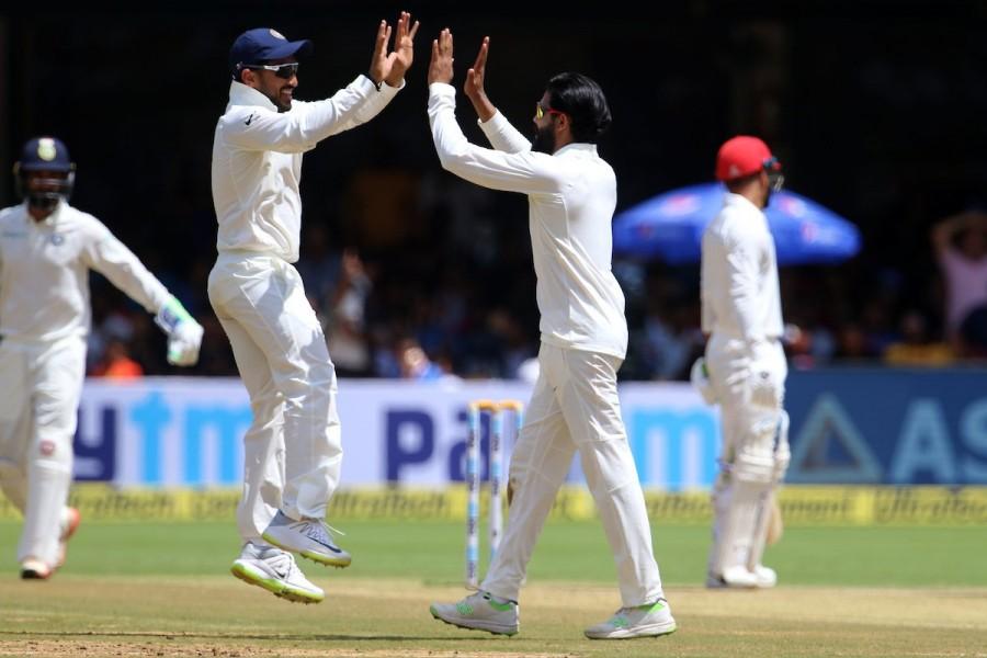 Umesh started the onslaught in the second innings by ripping through the Afghan top order, which saw Mohammed Shahzad (13), Javed Ahmadi (3) and Mohammad Nabi (0) back in the hut with just 22 runs on the board. Umesh's fellow pacer Ishant Sharma then struck with the wicket of Rahmat Shah (4) before Jadeja joined the party with the wickets of skipper Asghar Stanikzai (25), stumper Afsar Zazai (1) and Rashid Khan (12) in no time. Ishant then jolted the visitors again by breaking through the defences of Yamin Ahmadzai (1) as the Afghans started looking down the barrel. India beats Afghanistan,India vs Afghanistan,India vs Afghanistan Test,India vs Afghanistan test match,Ravichandran Ashwin