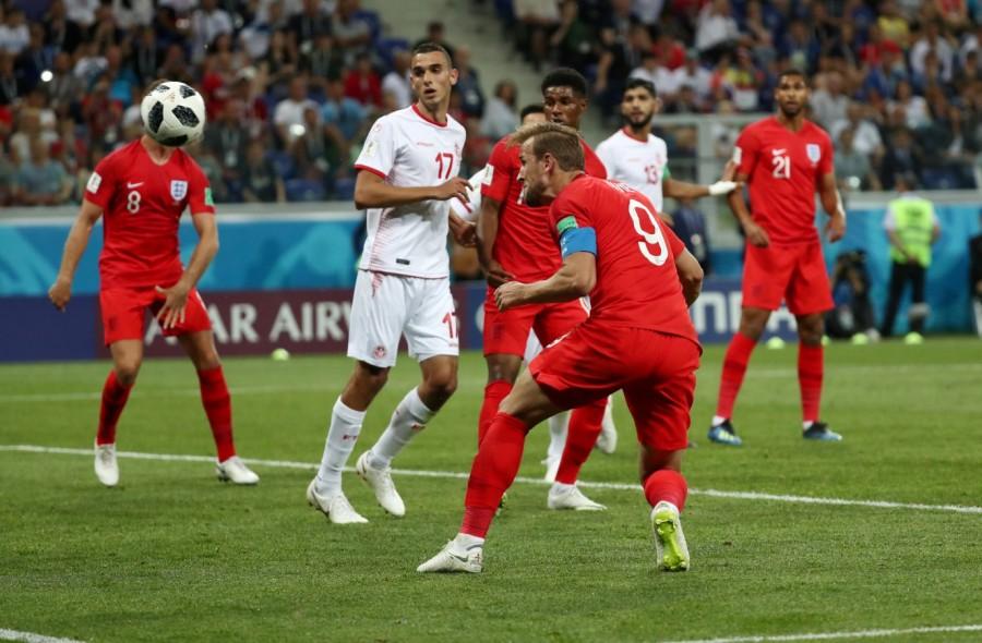 Captain Harry Kane scored a brace as England overcame Tunisia with a 2-1 victory in their FIFA World Cup Group G campaign opener at the Volgograd Arena here on Monday. The Tottenham centre-forward gave England the lead in the 11th minute but Ferjani Sassi converted a penalty to pull Tunisia level in the 35th minute. However, Kane headed home off a corner in the 90+1st minute to give England the winning goal. The North African side had survived an early onslaught and punched above their weight to counter a talented and youthful English team, playing in a 3-4-2-1 formation. Towards the end, Tunisia thought a draw was a fair result and decided to keep it that way until Kane brought out his second strike in the second-half injury time. England kept it late to seal the win but their overwhelming start nearly blew Tunisia away. England were all over Tunisia, beginning the match in an emphatic manner. 2018 FIFA World Cup,FIFA World Cup,FIFA World Cup 2018,England 2 - Tunisia 1,England beats Tunisia,FIFA World Cup pics,FIFA World Cup images,FIFA World Cup stills,FIFA World Cup pictures,FIFA World Cup photos
