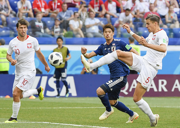 Jan Bednarek (R) of Poland scores during the second half of a World Cup Group H match against Japan in Volgograd in Russia on June 28, 2018. Japan advanced to the round of 16 despite a 1-0 loss to Poland. FIFA World Cup,Japan enter pre-quarters,Japan beats Poland,FIFA World Cup pre-quarterfinals,Group H,2018 FIFA World Cup,FIFA World Cup 2018