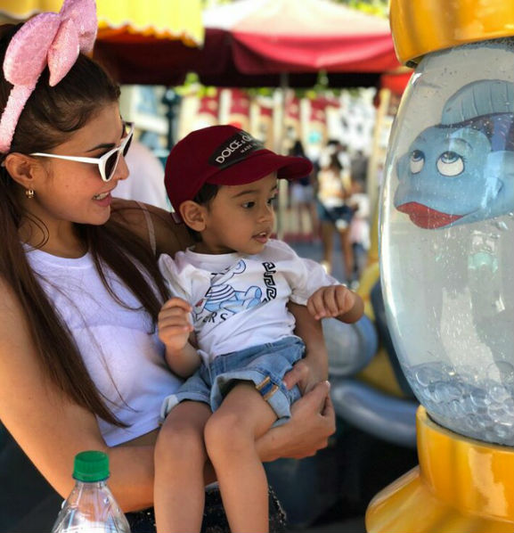 Jacqueline Fernandez, who is currently on a World Tour for Dabangg reloaded, took some time off her busy schedule to take a trip to Disney Land. The actress looked adorable in a white coloured co-ord trouser set and a Disney staple, Minnie Mouse headband teamed it up with a waist fanny pack like a boss! Jacqueline filled up her Instagram stories with memories from Disneyland, which were too cute to handle as she was seen having fun with her Race 3 co-star Salman Khan's nephew Ahil. Sharing frame-worthy photos from the trip, Jacqueline wrote: "When on tour be a tourist. My second Disney with this little cutie Ahil, thanks!" Jacqueline Fernandez,actress Jacqueline Fernandez,Jacqueline Fernandez at Disneyland,Dabangg reloaded,Dabangg tour,Salman Khan,Salman Khan nephew,salman khan nephew Ahil