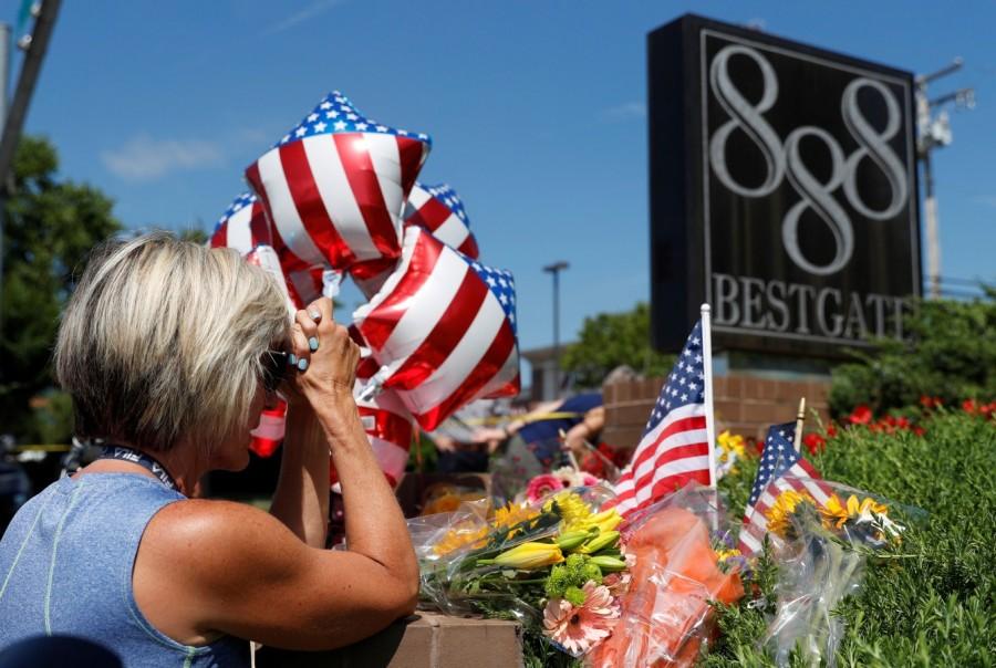 Kim Wither says a prayer at an impromptu memorial outside of the Capital Gazette, the day after a gunman killed five people inside the newspaper's building in Annapolis, Maryland, U.S. Maryland newspaper office,Maryland newspaper office shooting,shooting at Maryland newspaper office,Gazette newspaper