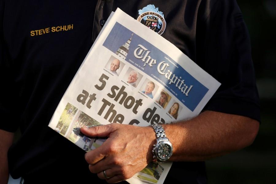 Steve Schuh, the County Executive of Anne Arundel County, Maryland, holds a copy of the Capital Gazette as he is interviewed the day after a gunman killed five people and injured several others at the newspaper's offices, in Annapolis, Maryland, U.S. Maryland newspaper office,Maryland newspaper office shooting,shooting at Maryland newspaper office,Gazette newspaper