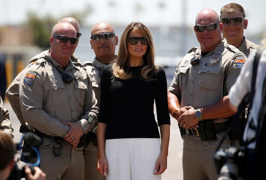 U.S. first lady Melania Trump poses with local law enforcement officers as she prepares to depart Phoenix Sky Harbor Airport after touring a nearby immigration detention facility for children in Phoenix, Arizona, U.S. Melania Trump,first lady melania trump,Arizona border detention center,detention center,Arizona detention center