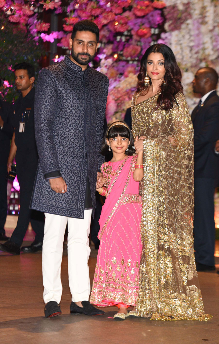 Aishwarya Rai Bachchan looked every bit of the diva at the event at Antilia here on Saturday in a saree with gold floral motifs, while husband Abhishek opted for a black sherwani and their daughter Aaradhya was decked up in a red and golden lehenga. Shah Rukh Khan,Aamir Khan,Abhishek Bachchan,Aishwarya Rai,Alia Bhatt,Ranbir Kapoor,Akash Ambani and Shloka Mehta's engagement,Akash Ambani and Shloka Mehta's engagement party,Akash Ambani engagement party,Shloka Mehta engagement party
