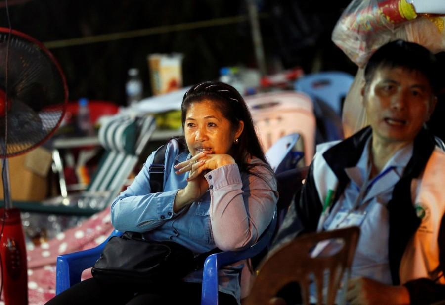 Family members wait near Tham Luang cave complex, as members of an under-16 soccer team and their coach have been found alive according to a local media report, in the northern province of Chiang Rai, Thailand, July 3, 2018. Missing youth soccer team,soccer team found alive,Missing boys found alive,Thailand cave,Tham Luang cave